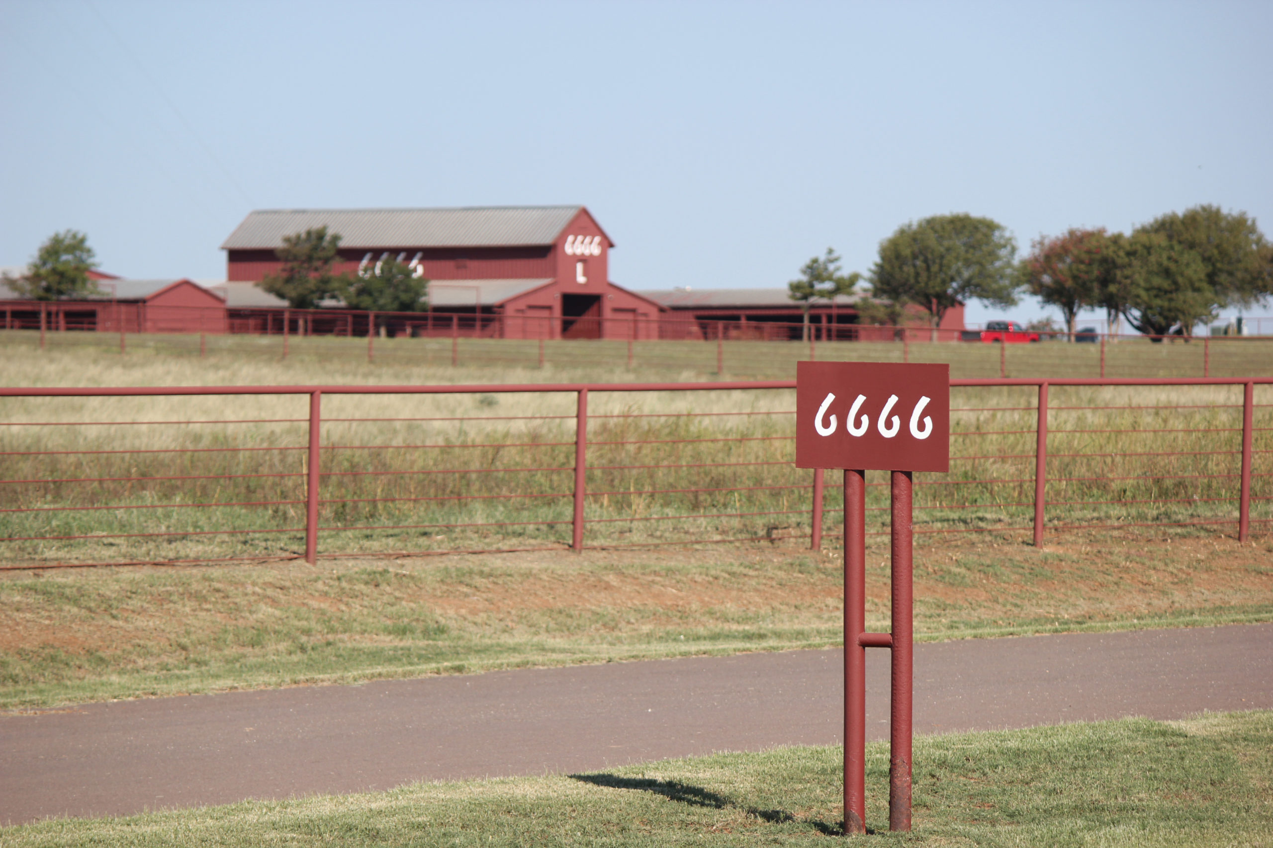 home-staging_01 The entrance to the Four Sixes Ranch, featuring the iconic 6666 sign and ranch headquarters in the background.